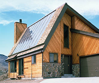 The collectors for a flat-plate solar water heating system have been installed on the roof of this house in Golden, Colorado.  Solar water heaters use the sun to heat either water or a heat-transfer fluid, such as an antifreeze mixture, in collectors usually mounted on a roof.  The heated water is then stored in a tank similar to a conventional gas or electric water-heater tank.  Some systems use an electric pump to circulate the fluid through the collectors.  These environmentally friendly systems can be cost competitive for providing domestic hot water.