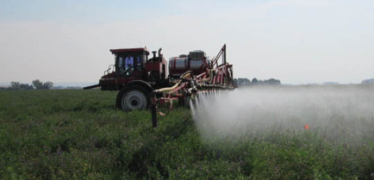 Case IH SPX 3300 applying disiccant to test plots