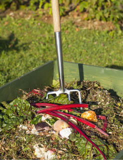 photo of a compost pile with a pitchfork in it